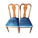 A pair of Queen Anne style mahogany chairs with shaped backs and vase shaped splats inlaid with