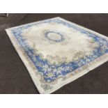 A lined Indian thick pile carpet with blue floral medallion and spandrels on ivory ground framed