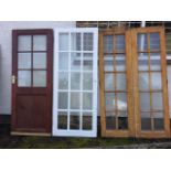 A pair of glazed hardwood patio type doors, each with ten panes - 46.25 span; a painted glazed