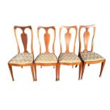 A set of four dining chairs with shaped Queen Anne style boxwood strung backs above floral