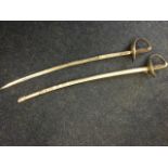 A near pair of antique sabres, one with plated steel blade and both with curved tapering guards