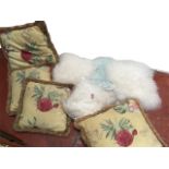 A set of four square wool, leather & suede fluffy cushions; and a set of four floral linen