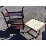 A mahogany trolley with turned handles above three rectangular tray shelves, raised on casters;