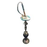 An eastern hookah pipe with glass reservoir on circular moulded base, the chromed column with bowl