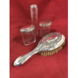 Three hallmarked silver topped faceted glass containers, two oval and one tubular; and an embossed