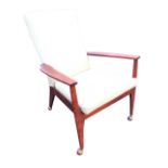 A Danish style armchair with upholstered padded back above a sprung seat with loose cushion, the