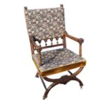 A nineteenth century walnut Glastonbury style armchair, the tapestry upholstered back with carved