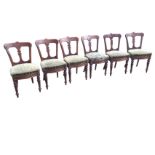 A set of six late Victorian mahogany dining chairs, the tapering backs with scrolled carving and