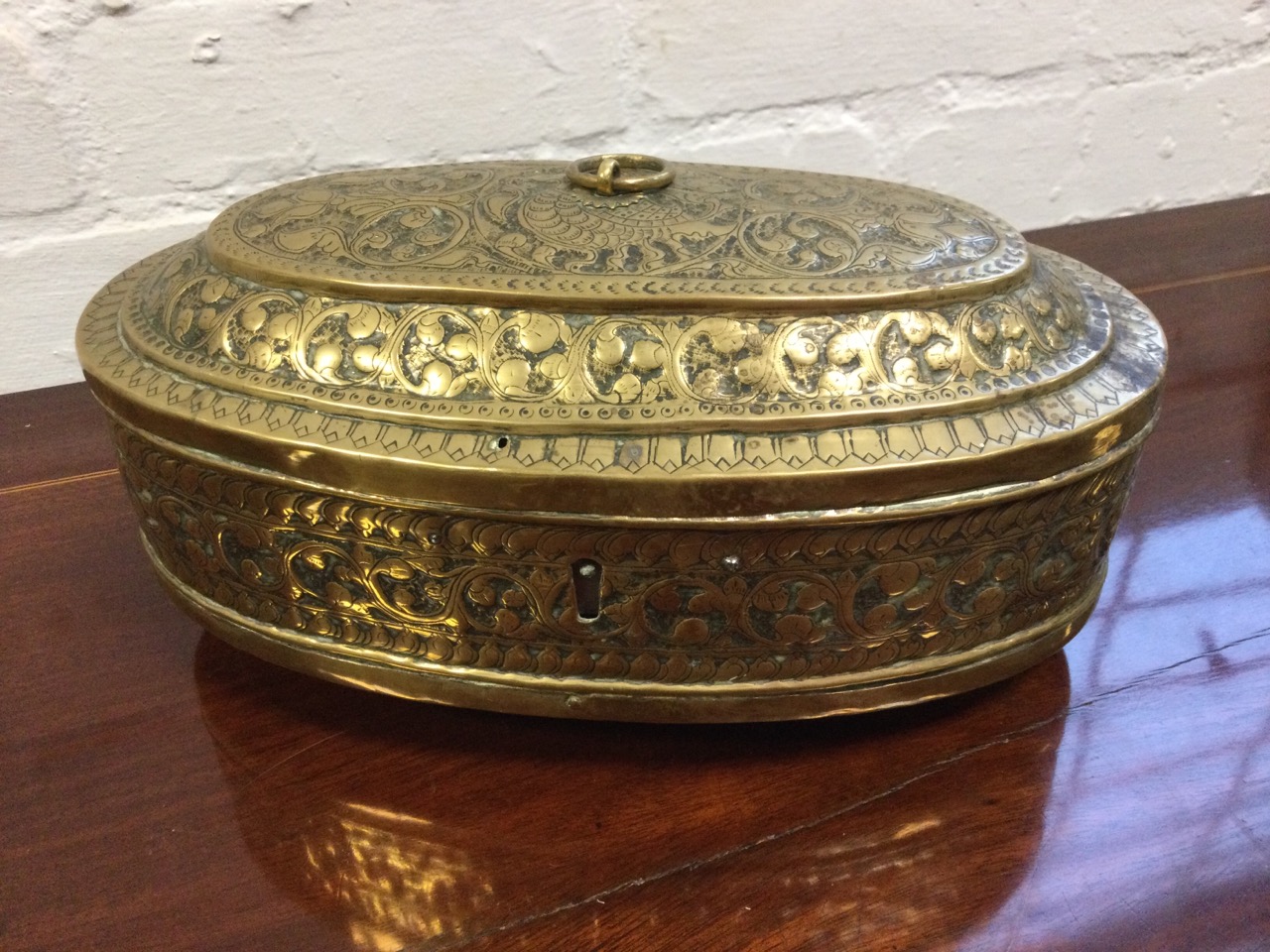 An oval nineteenth century brass box embossed with foliate scrolled decoration, with punched - Image 2 of 3