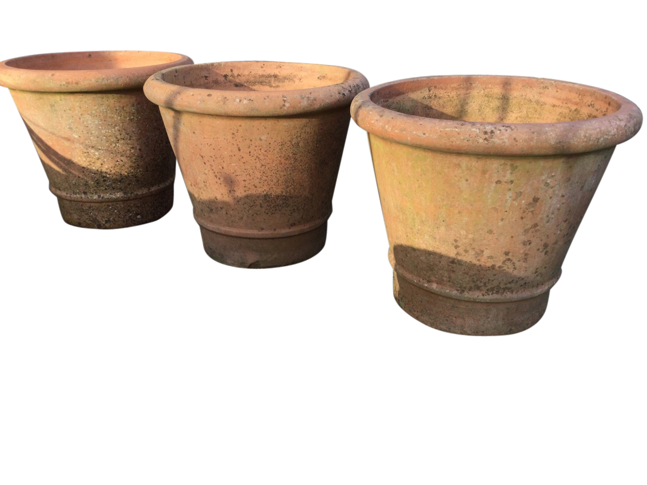 Three large tapering garden pots with cushion moulded rims, having moulded rings to bases. (16.