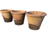 Three large tapering garden pots with cushion moulded rims, having moulded rings to bases. (16.