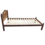 A reproduction pine single bed, having arched fielded panelled headboard above a rectangular slatted
