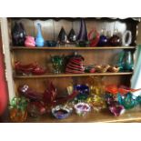 A collection of Murano glass, mainly abstract vase forms in many colours, bowls, a handbag shaped