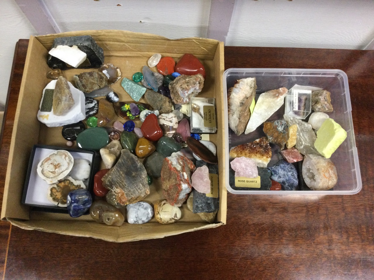 A collection of geological specimens including rose quartz, amethyst, fluorspar, polished stones,