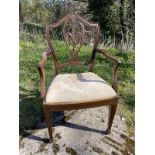 A Hepplewhite mahogany elbow chair with arched shield back above pierced carved splat, the drop-in