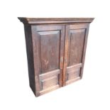 A Georgian oak cupboard with moulded cornice above fielded panelled doors enclosing adjustable