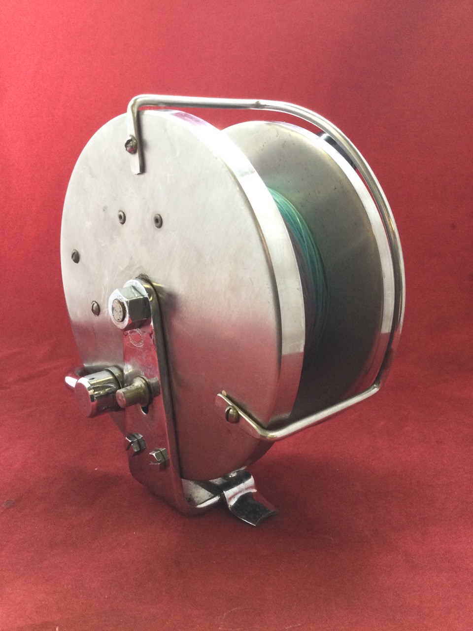 A large 6in Alcock sea fishing reel with steel drum and chrome mounts.