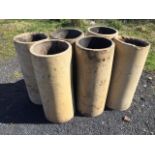 A set of six tubular stoneware chimneypots. (24.5in x 10.5in)