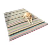 A large kilim woven with candy coloured stripes, having tasselled trim to ends. (107in x 90in)