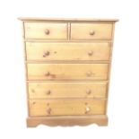 A Victorian style pine chest of drawers, the moulded top above two short and four long knobbed