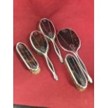 A deco ladies tortoiseshell & hallmarked silver dressing table set with two pairs of brushes and