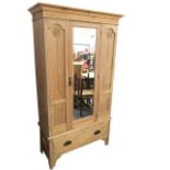 A late Victorian satin walnut wardrobe, with moulded cornice above a central bevelled mirror door