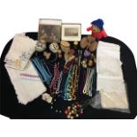 Miscellaneous items including embroidered tableclothes, sets of mats, a Paddington bear, costume