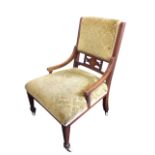 A Victorian mahogany nursing chair with upholstered back above a floral marqutery inlaid pierced