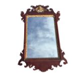 A Georgian mahogany Chippendale style mirror, the fretwork crest with pierced gilt carved bird above