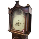 A nineteenth century oak longcase clock, the hood with draped style cornice above an arched door