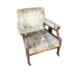 A Victorian rosewood armchair with padded back above a sprung seat, the arms with elbow pads on