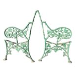 A pair of Victorian cast iron bench ends, moulded with leaves & tendrils having scrolled arms and