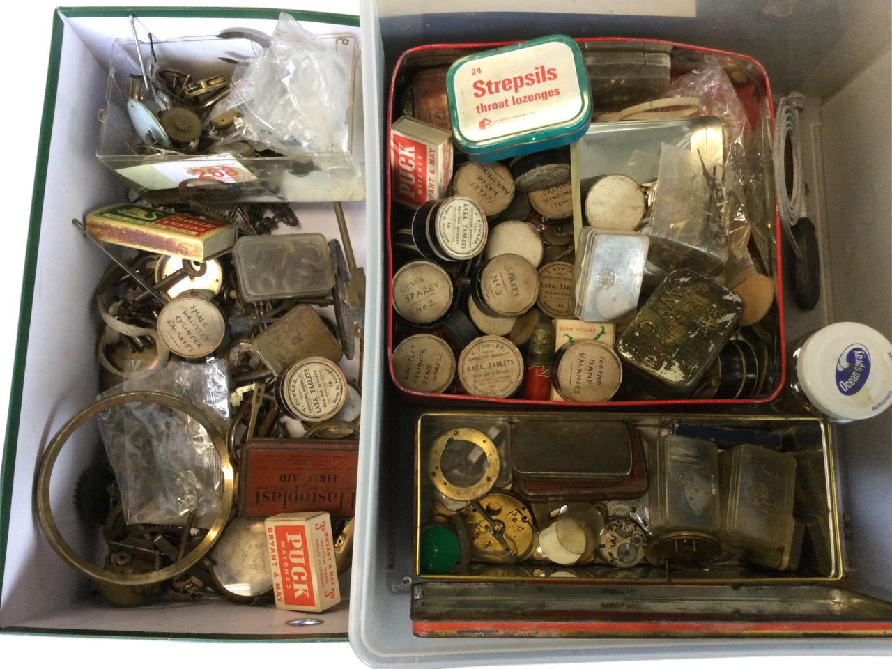 The contents of a watchmakers workshop including springs, movements, keys, parts, dials, fine