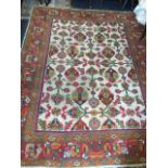 A large turkey style carpet with floral motifs on ivory field, the frieze of linked foilage on red