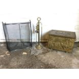 A rectangular embossed brass coalbox; a set of brass firetools on column stand; and a brass framed