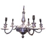 A silver plated hanging chandelier with column supported by a chain above a bun boss with floral and
