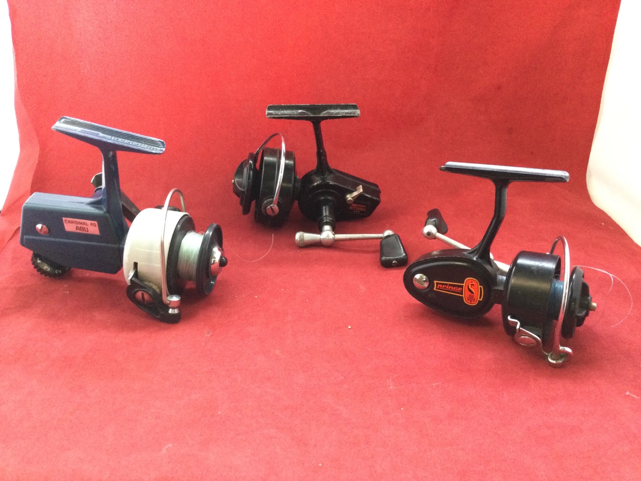 An Abu Cardinal 40 fixed spool spinning reel; a French Mitchell Garcia 324 spinning reel; and a