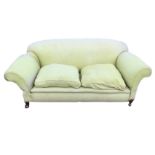 A drop-arm "country house" sofa, with padded back and arms above loose cushions with sprung seat,