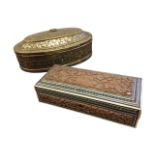 An oval nineteenth century brass box embossed with foliate scrolled decoration, with punched