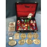 A pistol case containing a quantity of target shooting medals, some enamelled, ribboned, etc;