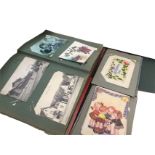 A collection of postcards contained in two albums including silks, childrens, loose cards,