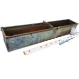 A long rectangular galvanised trough with tubular rim. (100in x 18.5in x 17in)