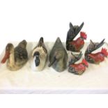 Three large carved & painted decoy style ducks; and a graduated set of three carved wood