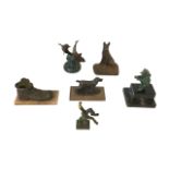 A group of bronze & cast iron sculptures, some on wood & marble plinths, including dolphins, dogs, a