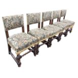 A set of five Caroleon style heavy oak dining chairs with tapestry upholstery, raised on barleytwist