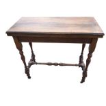 A Victorian mahogany turn-over-top card table, the twin flaps having baize lined interior, raised on