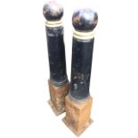 A pair of tapering cast iron bollards with moulded rings and ball finials. (44.5in) (2)