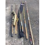 Four miscellaneous sea fishing rods; and a three-piece salmon fly rod. (5)