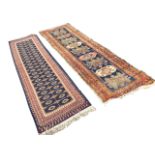 An antique Turkish runner woven with nine geometric panels on blue field, framed by three floral