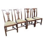 A set of four Chippendale style mahogany dining chairs with scalloped back rails above pierced